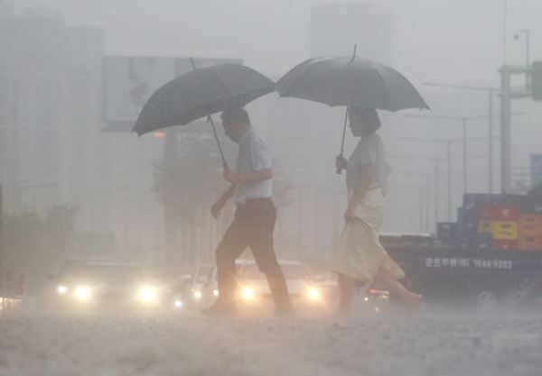 서울 여의대로 횡단보도 위로 우산을 쓴 시민들이 지나고 있다. [사진=연합뉴스]