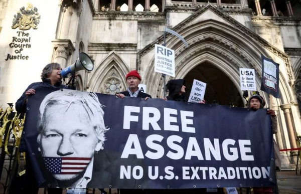 Supporters of Julian Assange display signs and a banner, outside the Royal Courts of Justice in London, Britain December 10, 2021. REUTERS/Yonhap