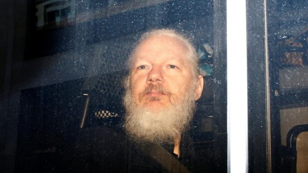 WikiLeaks founder Julian Assange is seen in a police van, after he was arrested by British police, in London. [Reuters= Yonhap News]