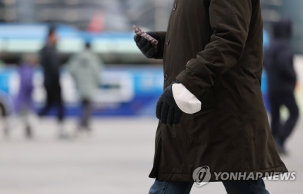 지난 4일 오후 서울 광화문광장에서 한 시민이 마스크를 벗은 채 걸어가고 있다. 연합뉴스