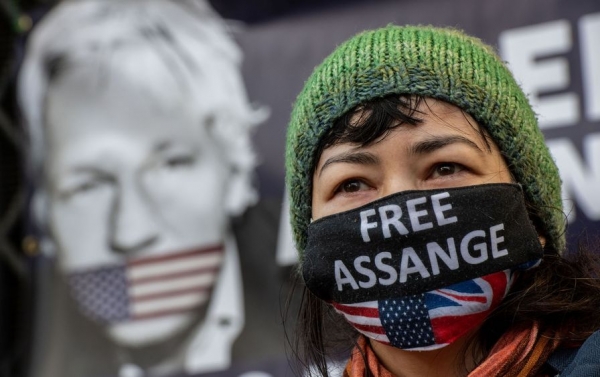 Supporters of Julian Assange react as the judgment is announced outside the Royal Courts of Justice on December 10 in London. The High Court ruled that Assange can be extradited to the United States, where he is charged with hacking and other crimes. (Source=The Nation)